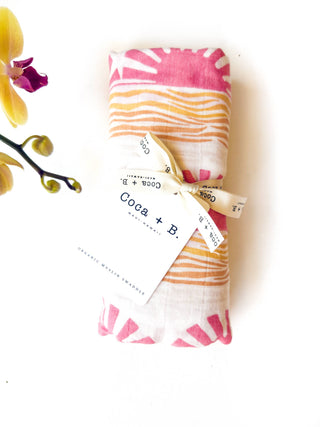 Organic Pink Sun + Wave Baby Swaddle | Coastal Nursery Decor