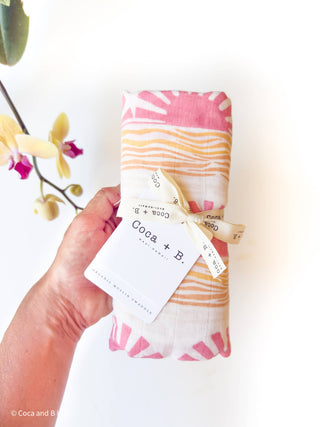 Organic Pink Sun + Wave Baby Swaddle | Coastal Nursery Decor