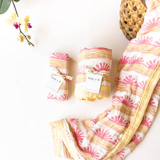 Organic Pink Sun + Wave Baby Swaddle | Coastal Nursery Decor