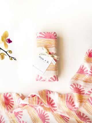 Organic Pink Sun + Wave Baby Swaddle | Coastal Nursery Decor